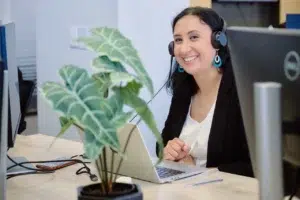 A smiling woman in a call center environment, part of a corporate branding photography session for a Cape Town-based business.