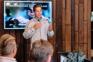 A professional speaker at an IWC Schaffhausen watchmaking masterclass event, photographed in Cape Town.