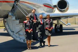 Flight crew in front of a VistJet private jet